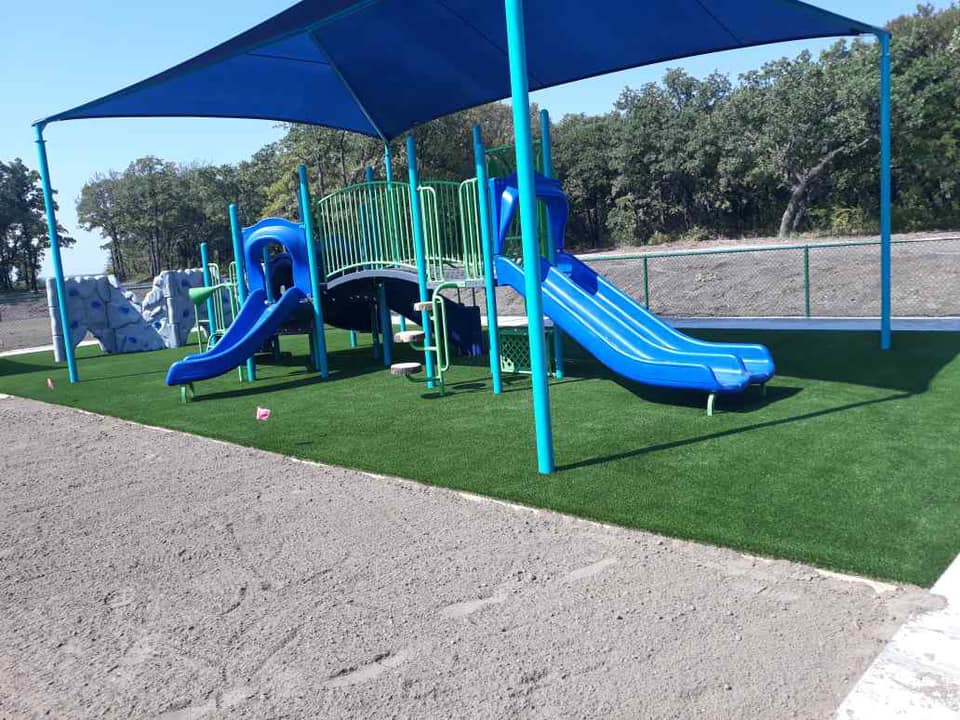 Kenneth Copeland Ministry synthetic playground grass with padding
