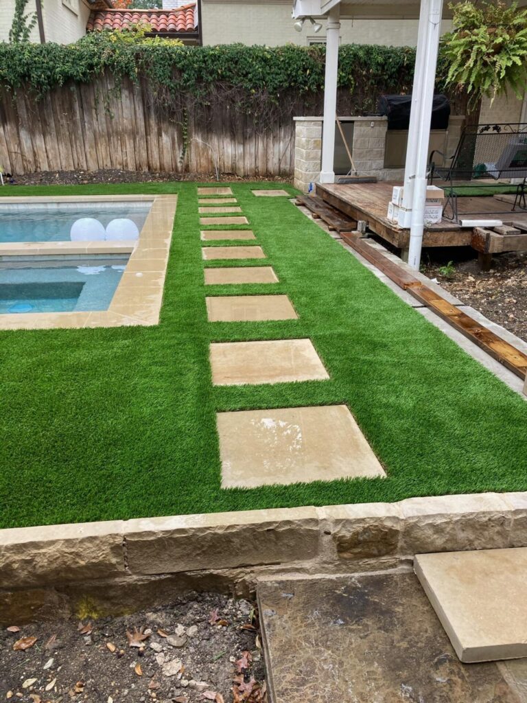 Side view of turf installed around brick pavers in Highland Park